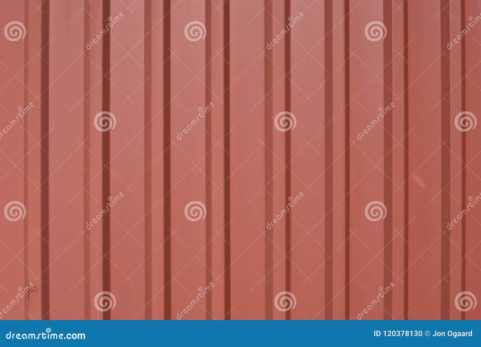 worn, corrugated trapezoidal metal panels with brick red powder coat and signs of wear and tear.