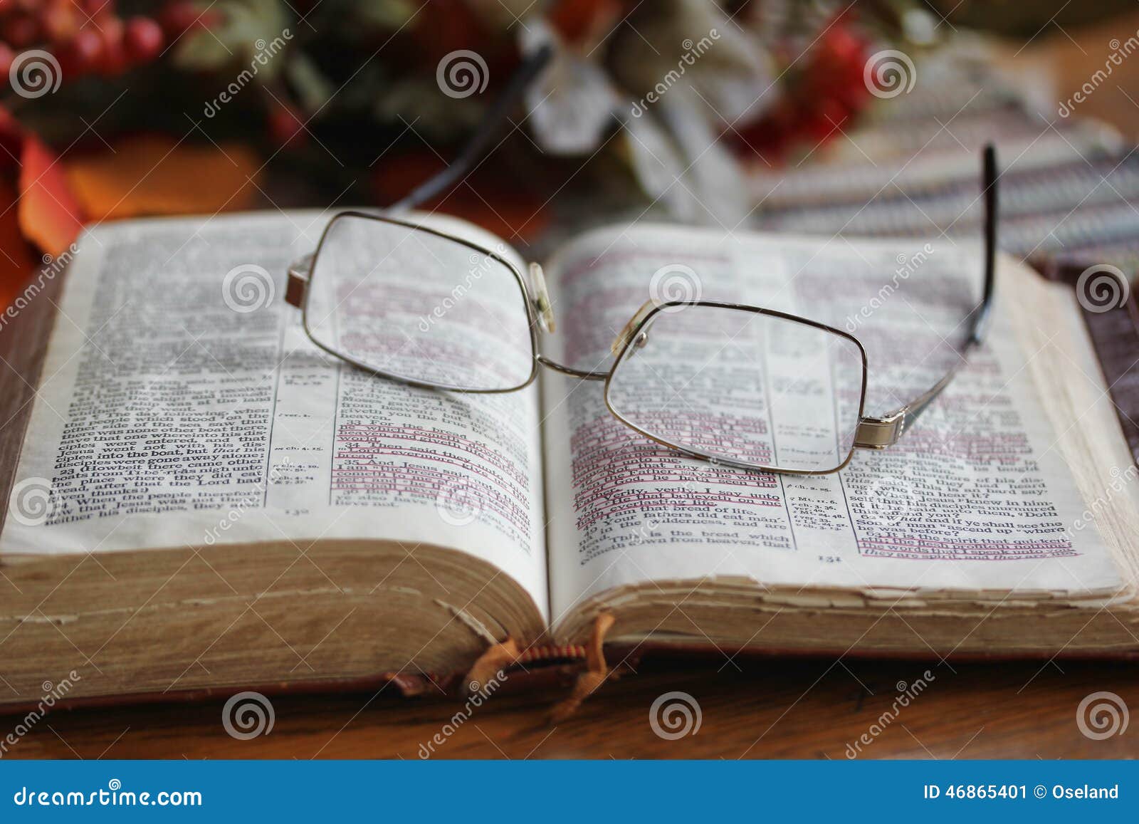worn open bible with glasses