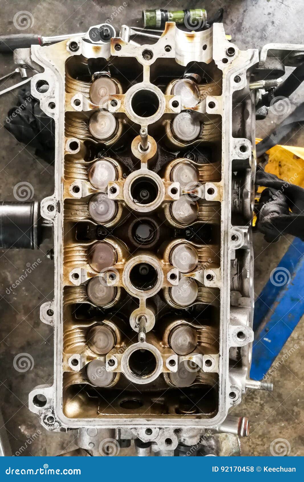 worn uto car engine valves being serviced at garage