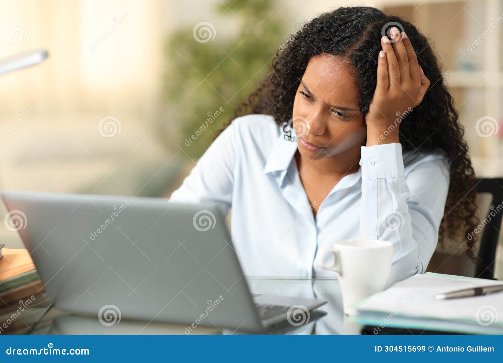 worried black teleworker working at home