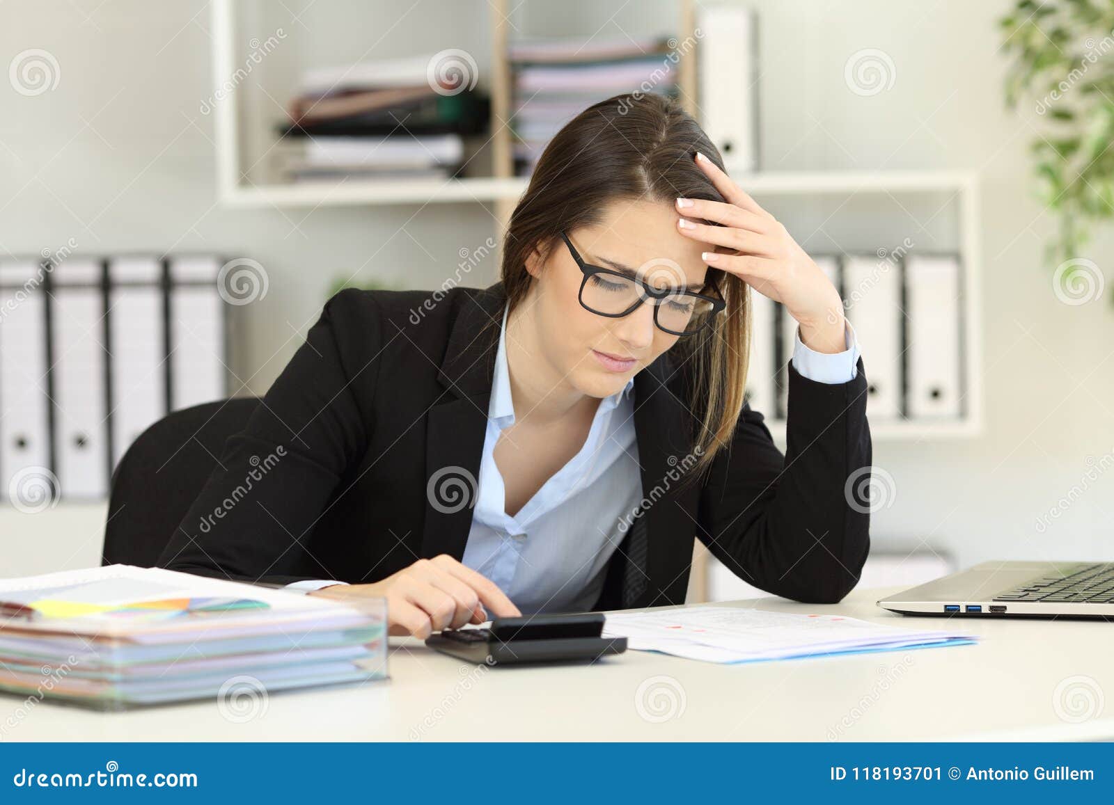 worried bookkeeper calculating expenses at office