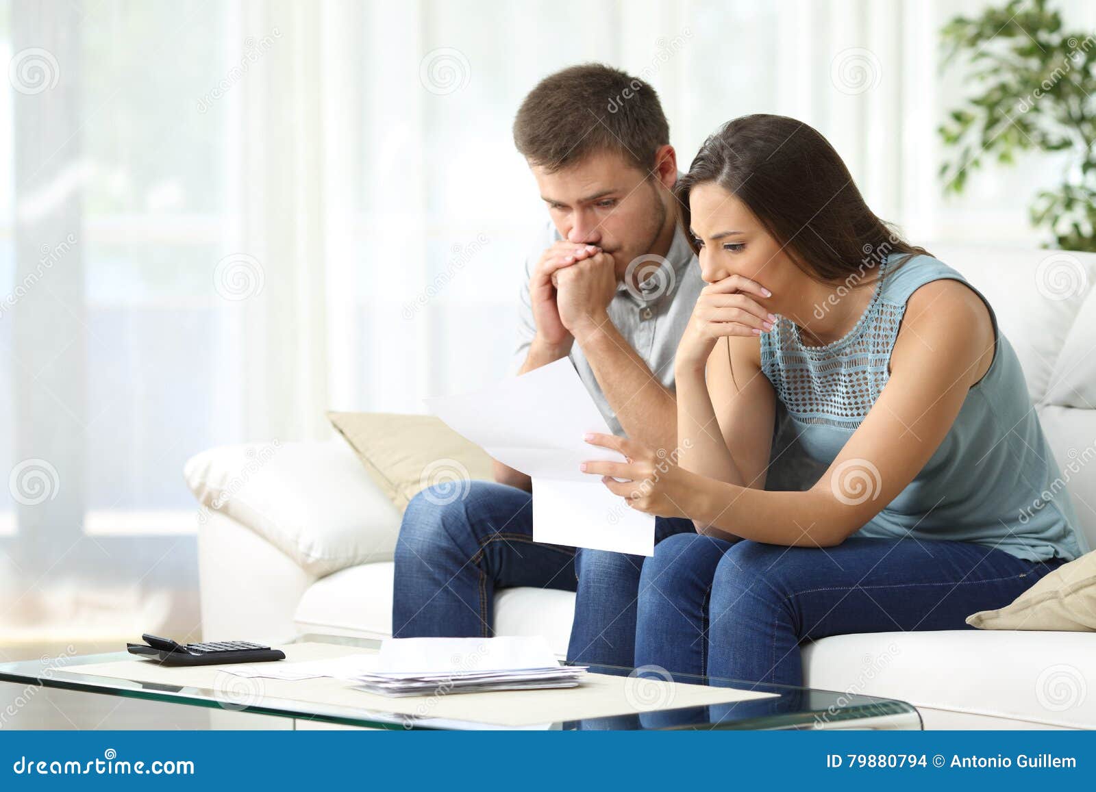 worried couple reading a letter