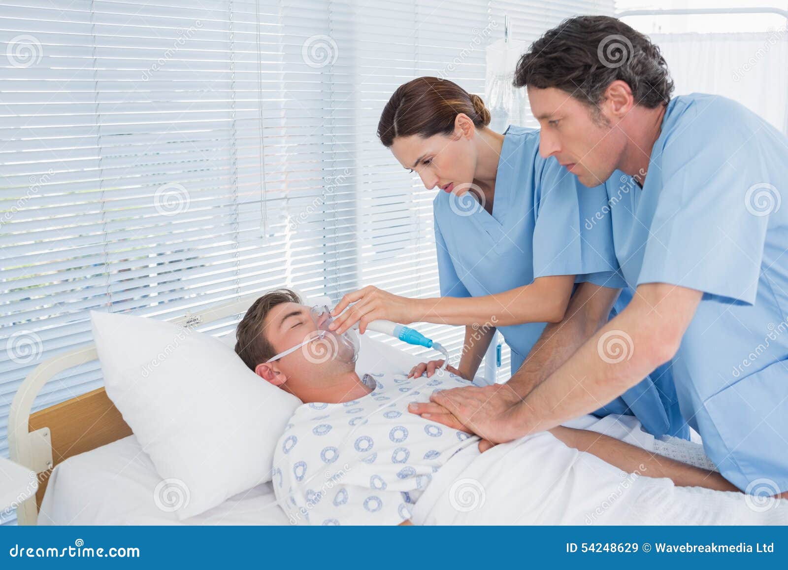 Worried Doctors Doing Heart Massage And Holding Oxygen Mask Stock Image