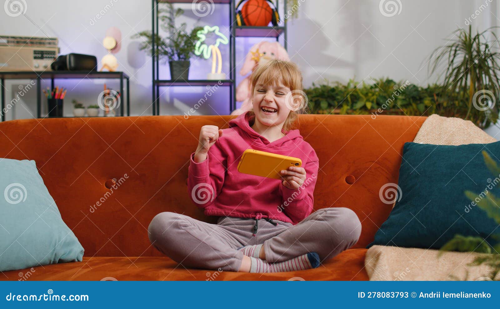 Worried Funny Child Kid Girl Playing Online Racing Simulator or Shooter Video Games on Smartphone Stock Image