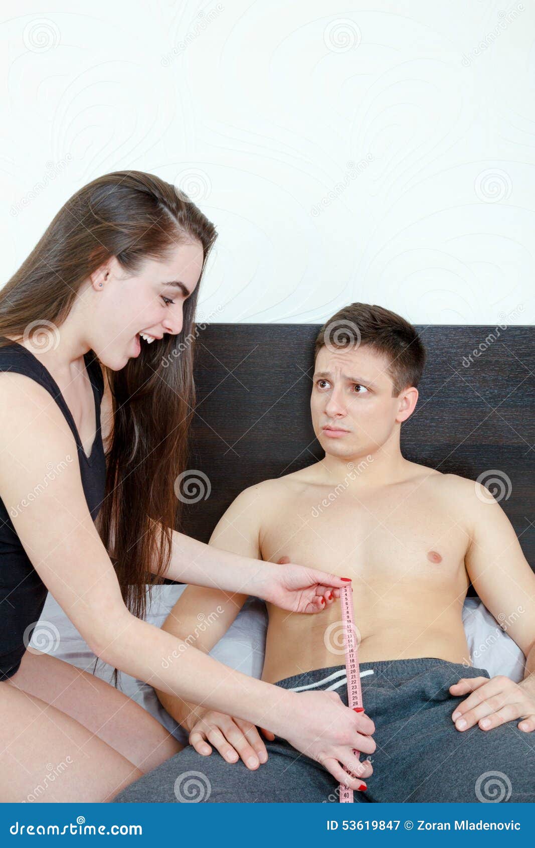 Worried Man Looking at Woman Measuring Size of His Penis Stock Image