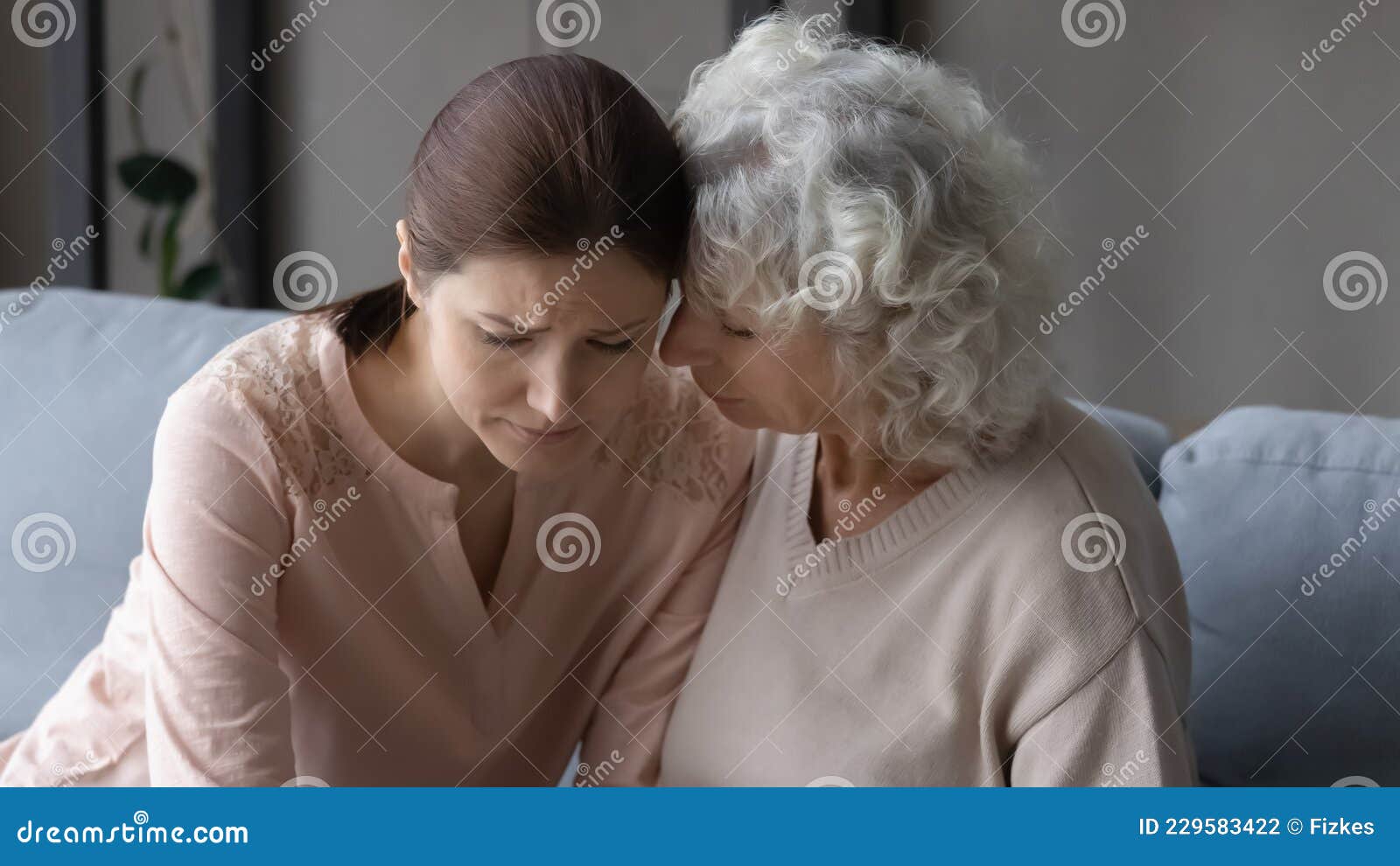 Worried Old Mature Mother Comforting Stressed Daughter image