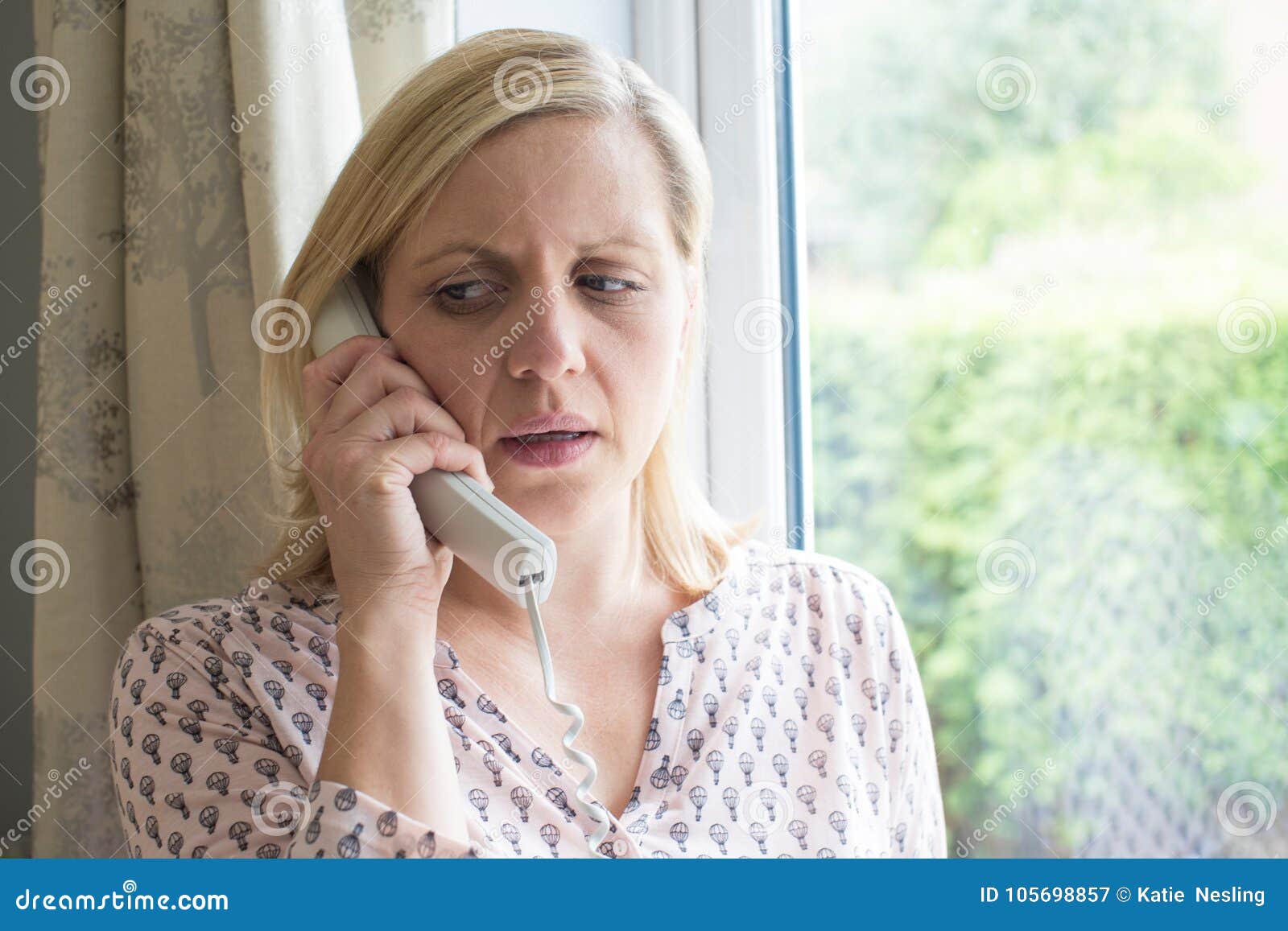 Worried Woman Answering Telephone at Home Stock Image - Image of