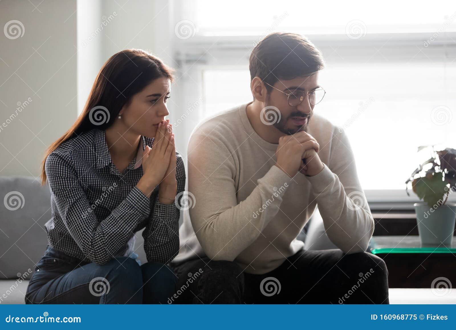 Worrying Woman Sitting Near Offended Husband, Saying Sorry. Stock ...