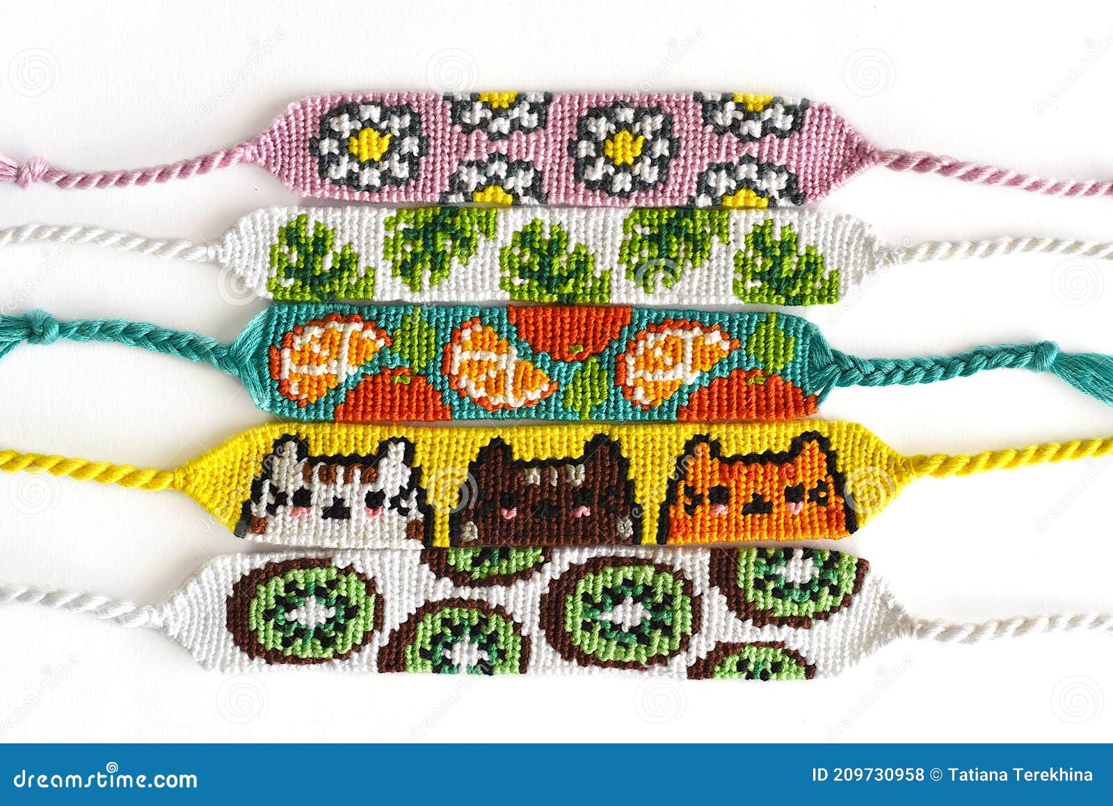 Woven DIY friendship bracelets handmade of embroidery bright thread with  knots on white background Stock Photo - Alamy