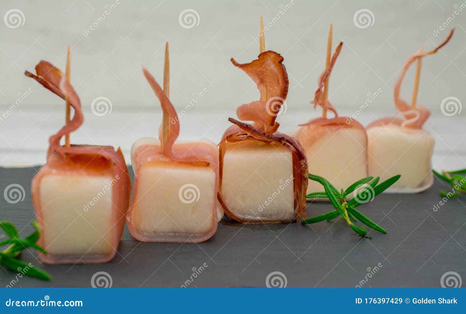 Wrap a Slice of Parma Ham Around Each Piece of Melon.Â Stock Image