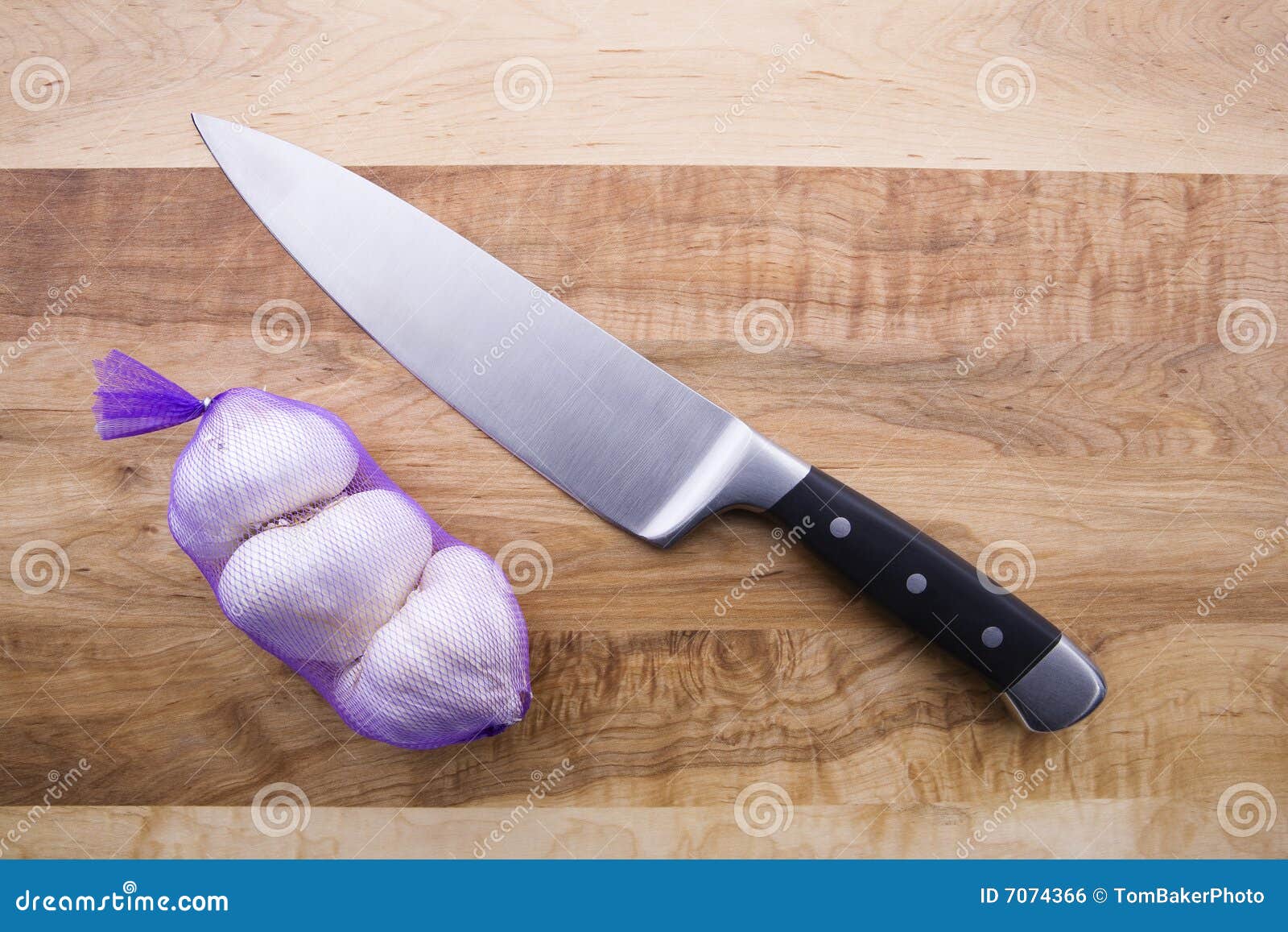 Wrapped Garlic and Knife stock photo. Image of garlic 7074366