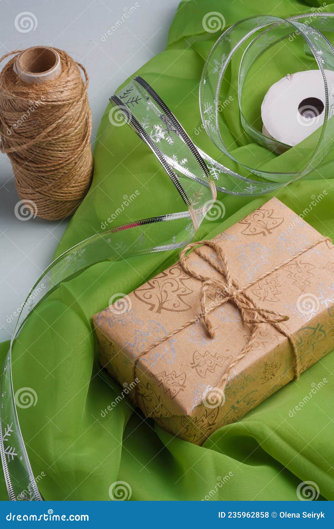 Eco gift box in craft paper branch on linen fabric. Zero waste