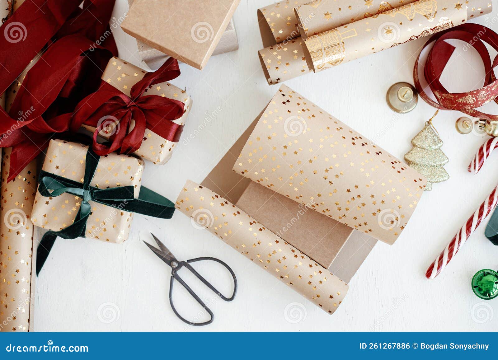 Christmas flat lay. Stylish christmas gift wrapped in gold paper and green  ribbon. Merry Christmas Stock Photo by Sonyachny