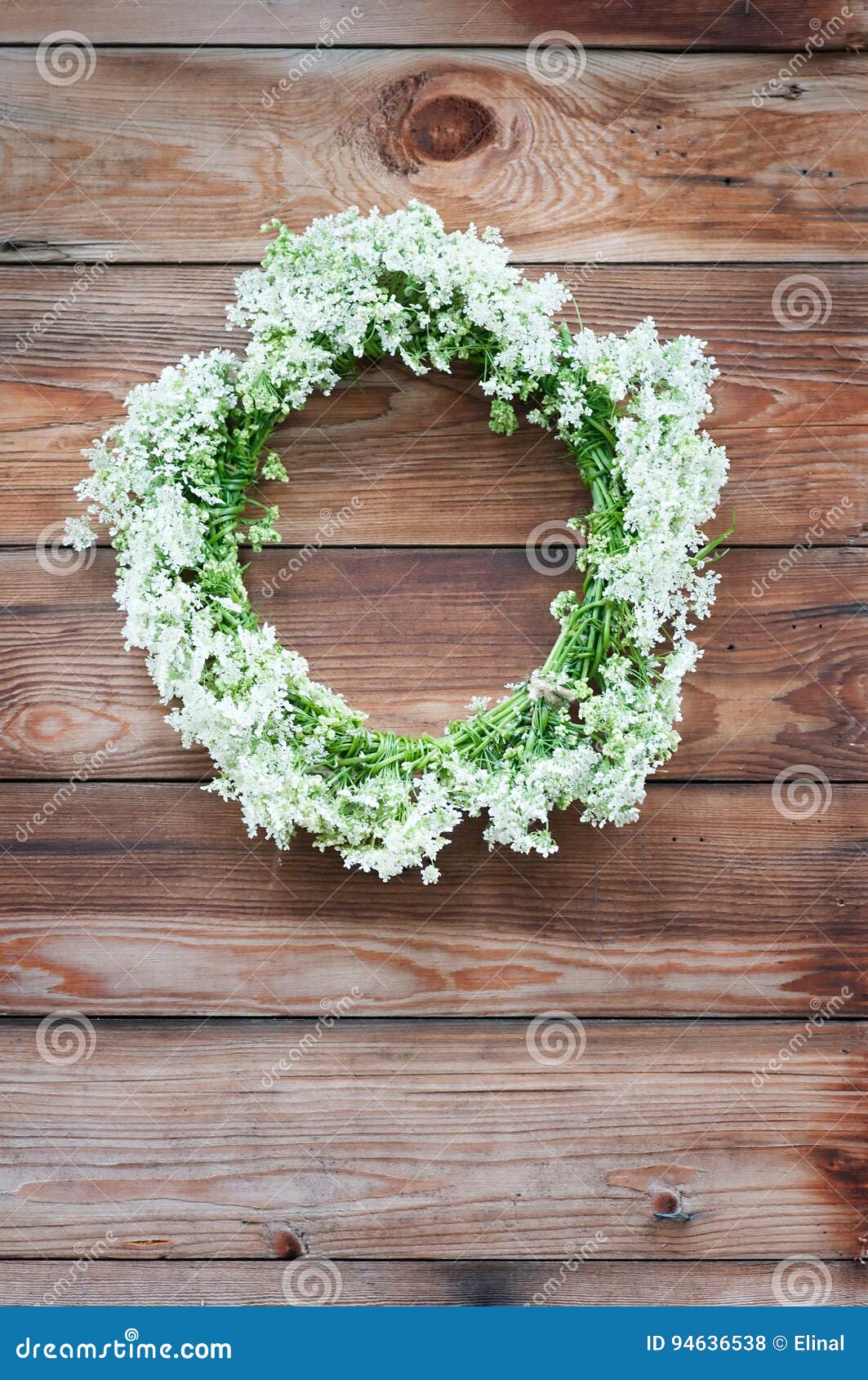 Wreath with White Flowers on a Wooden Background. Rustic Style Stock