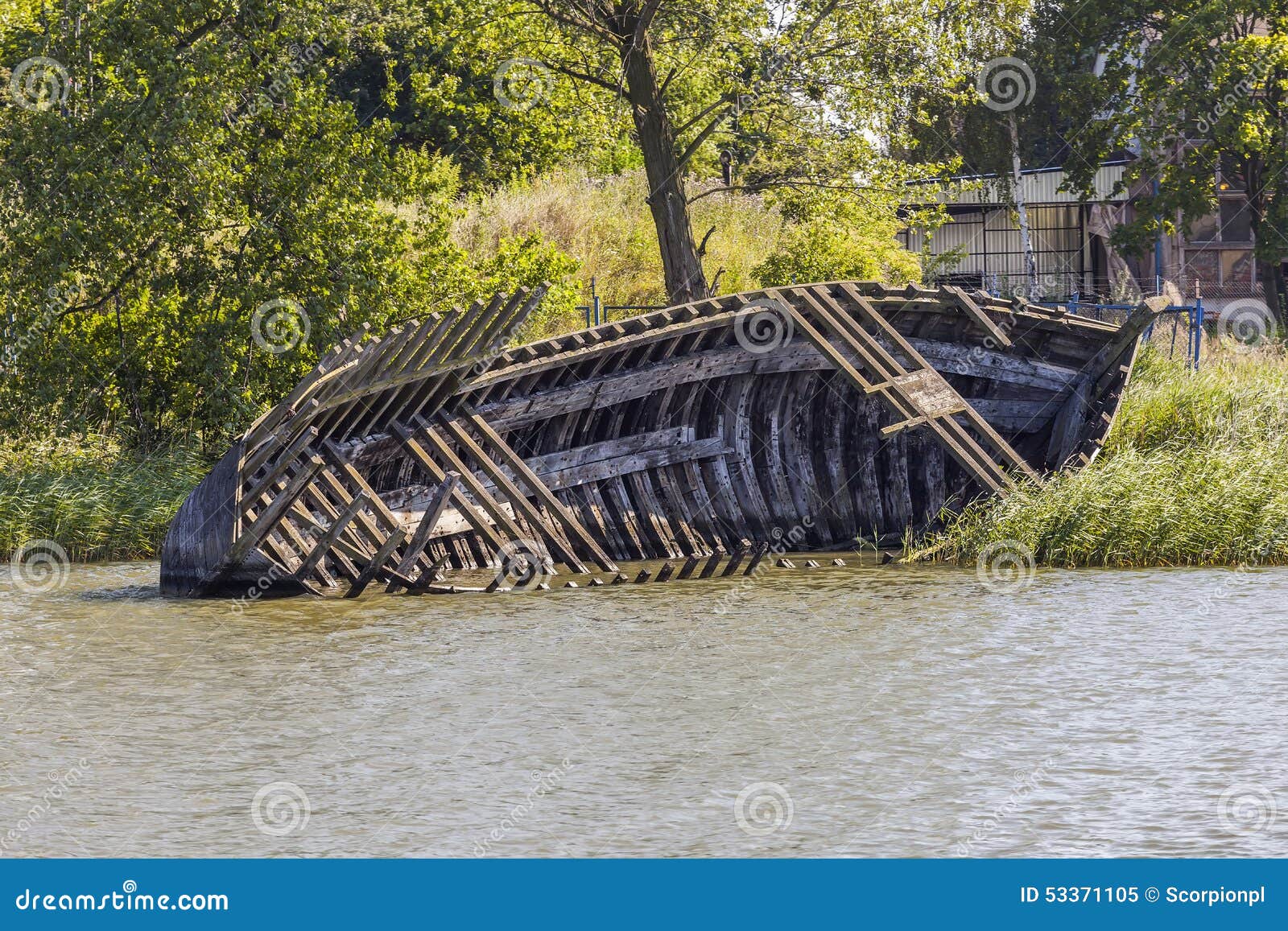 Wreck of the old wooden boat. Partly submerged old wooden boat