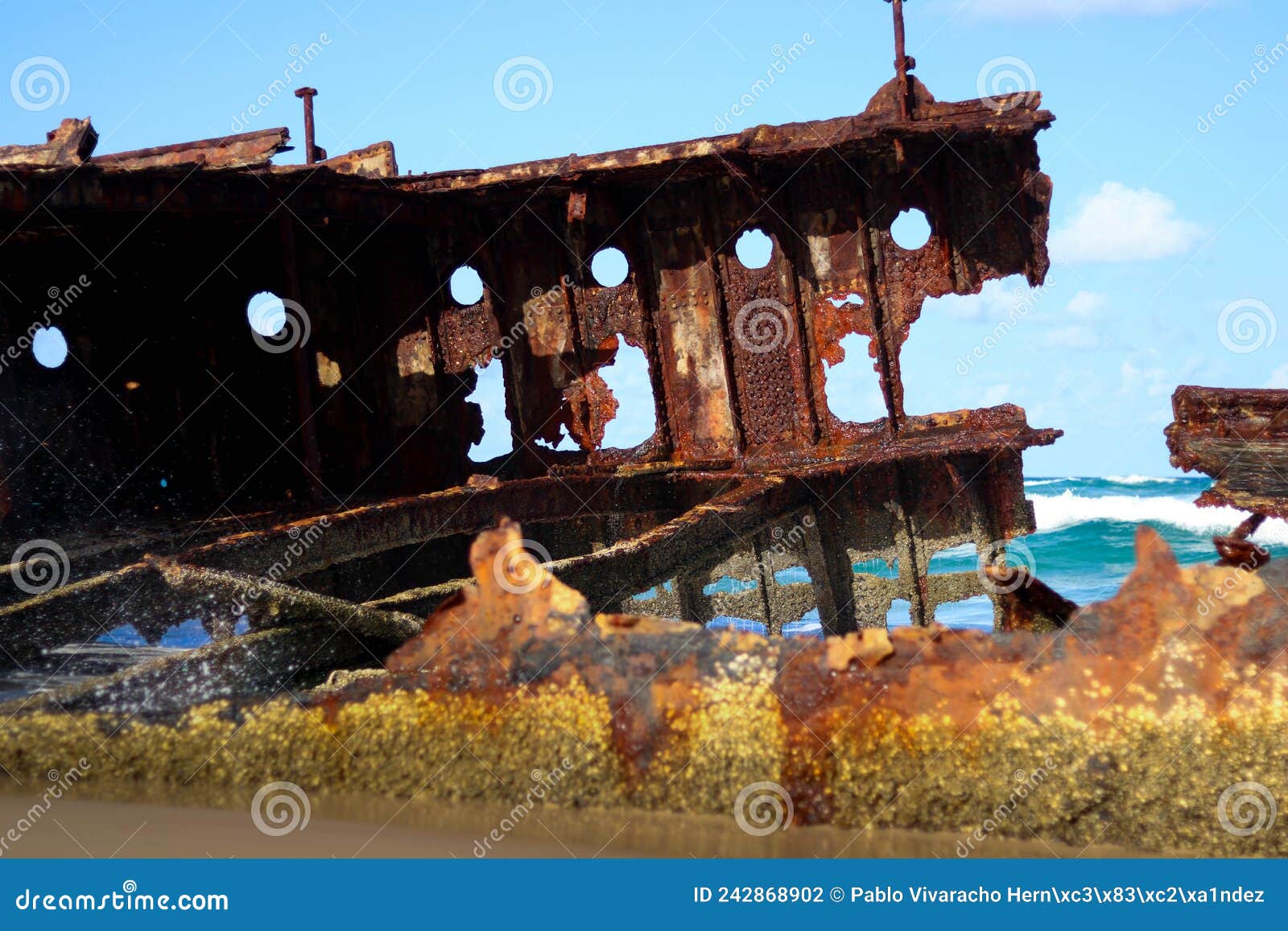 wreckage of a rusted sunken ship stranded on the sand of australia
