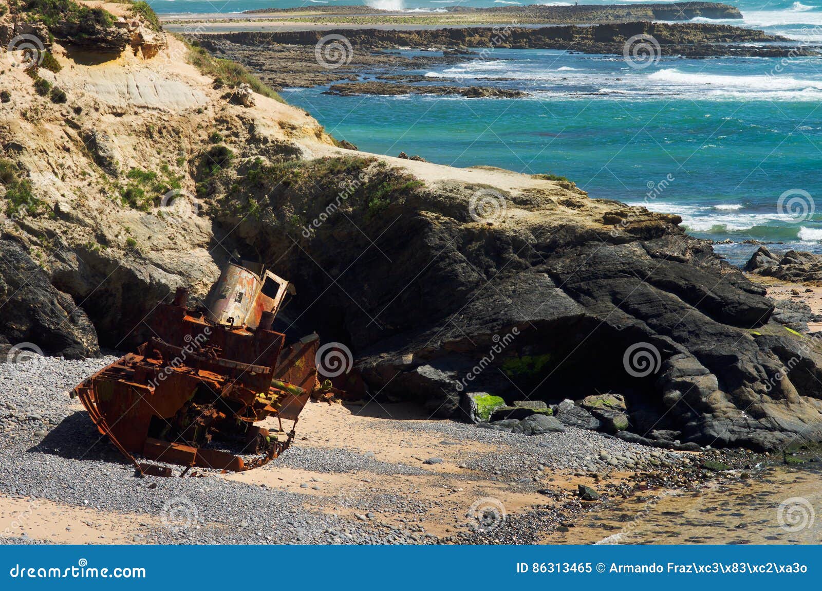 wrecked old and ruined pusher boat on the beach