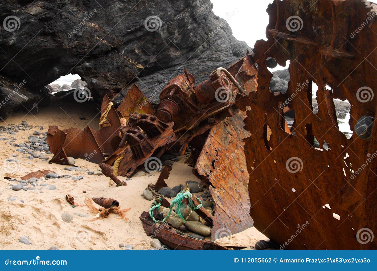 wrecked pusher boat bow, broken and rusted at the beach