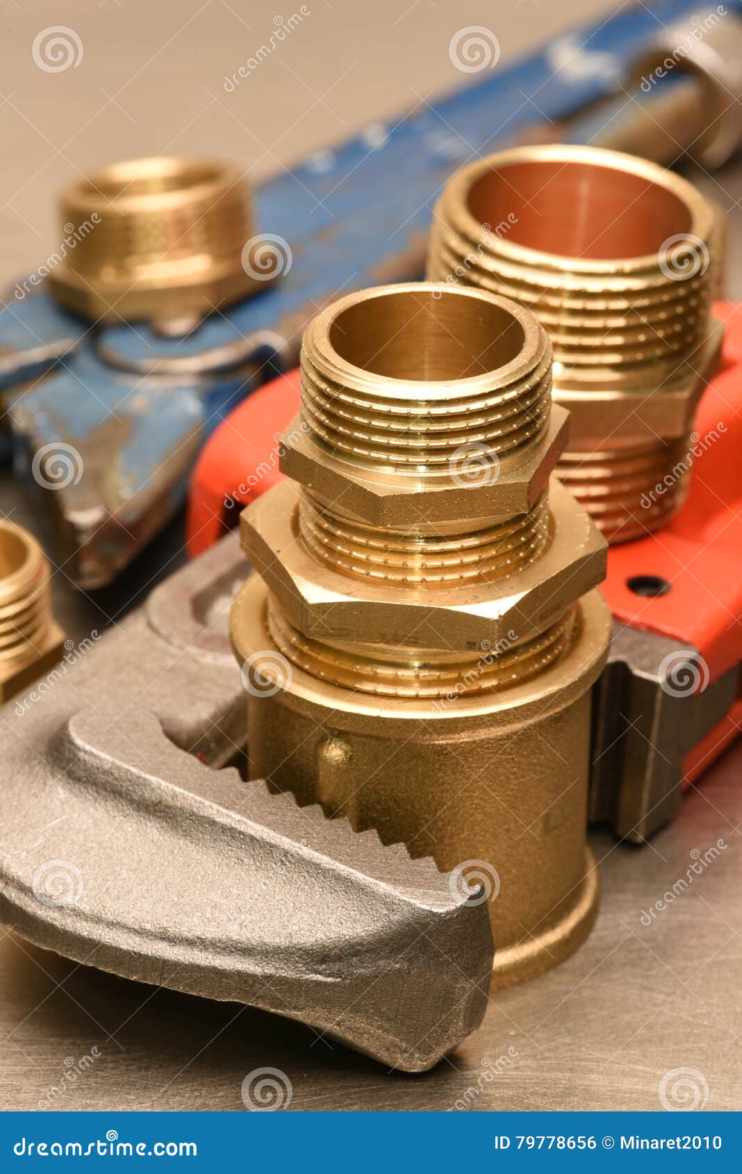 Wrench and brass fittings stock photo. Image of industrial 79778656