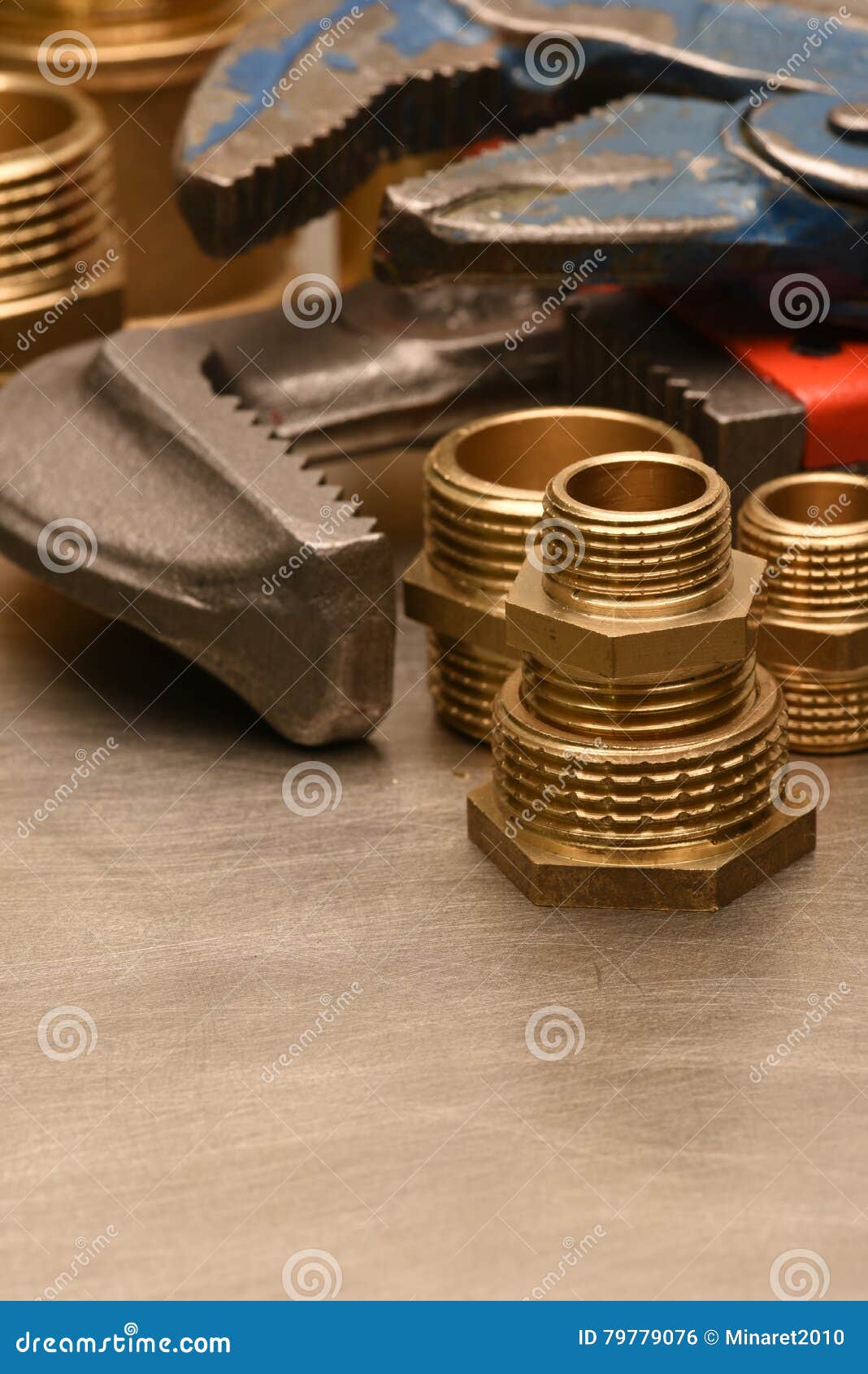 Wrench and brass fittings stock photo. Image of construction 79779076