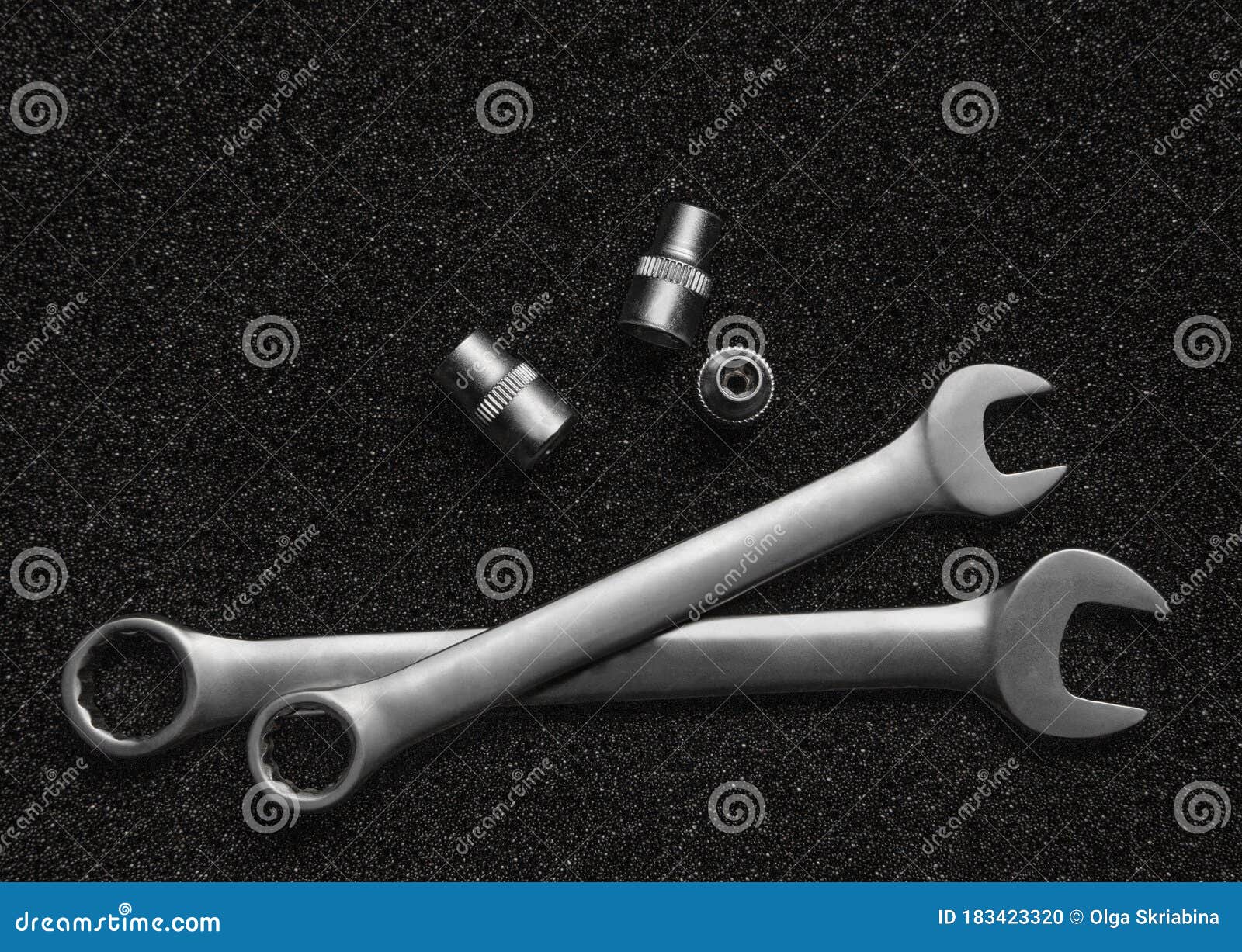 Wrenches and Socket Wrenches on a Black Grainy Background Stock Photo