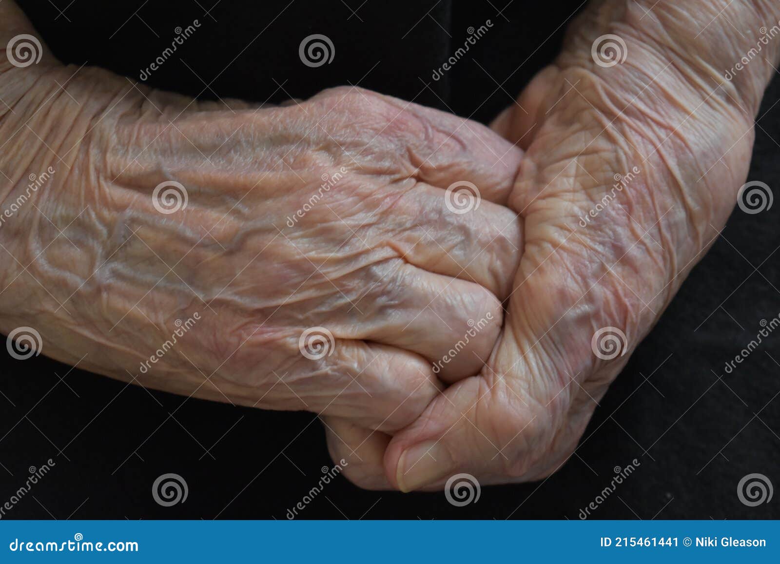 wrinkled and old grandmother's hands clasped together
