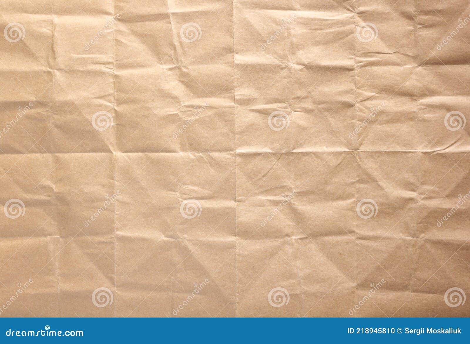 Wrinkled paper texture as background texture. Folded craft paper