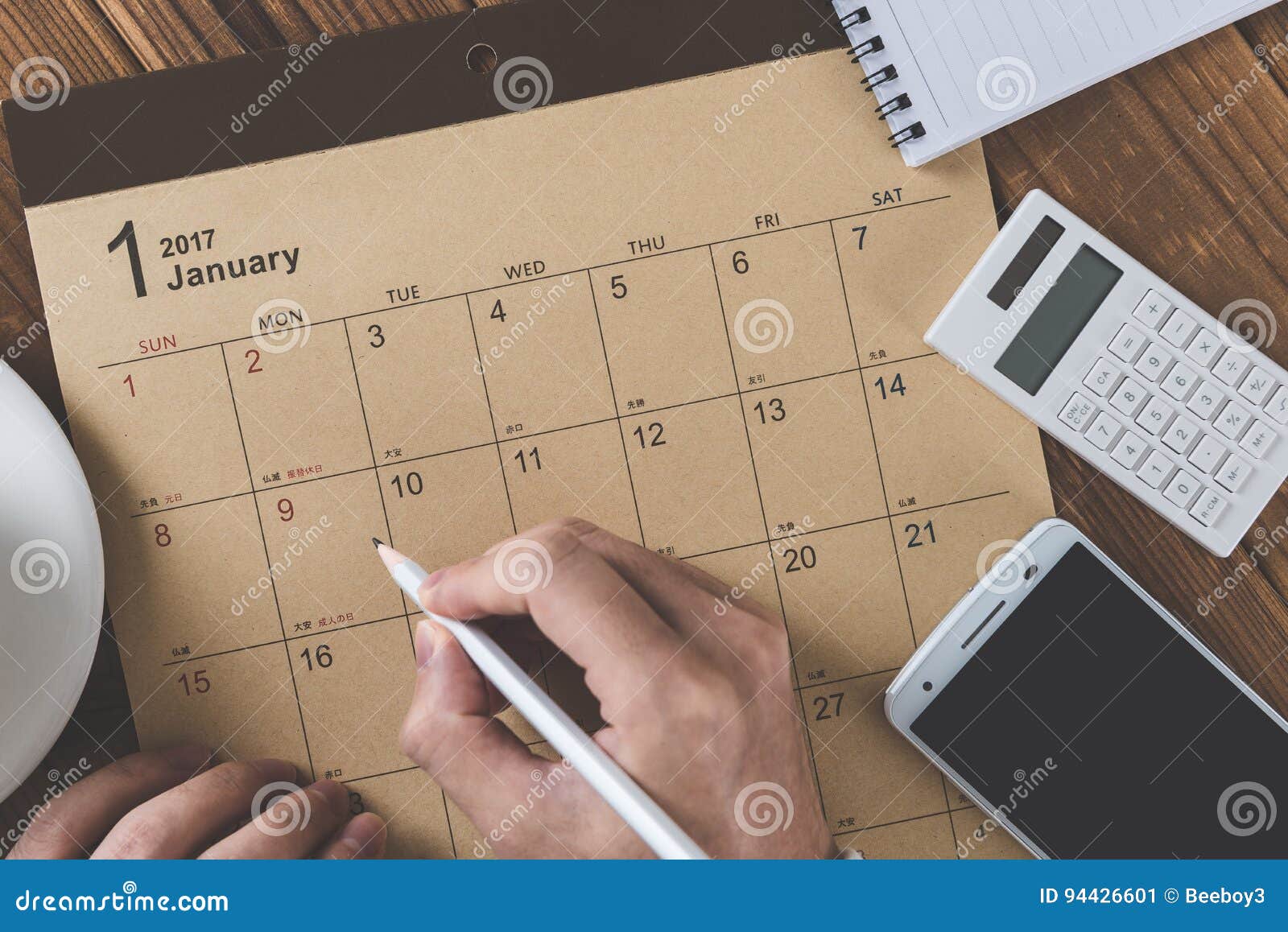 Write a Schedule To a Calendar Placed on a Wooden Table Stock