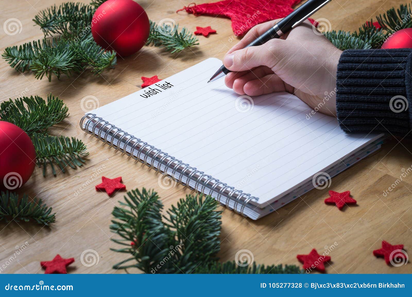 Writing a Wish List for Christmas on a Notepad with Christmas De ...
