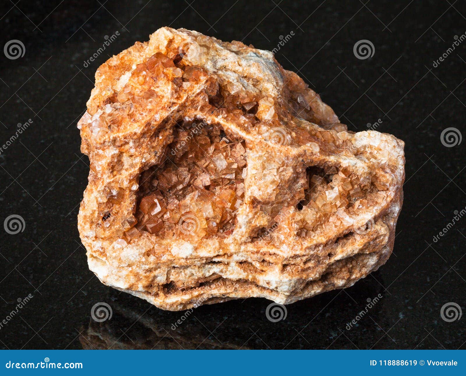 wulfenite crystals on rough rock on black