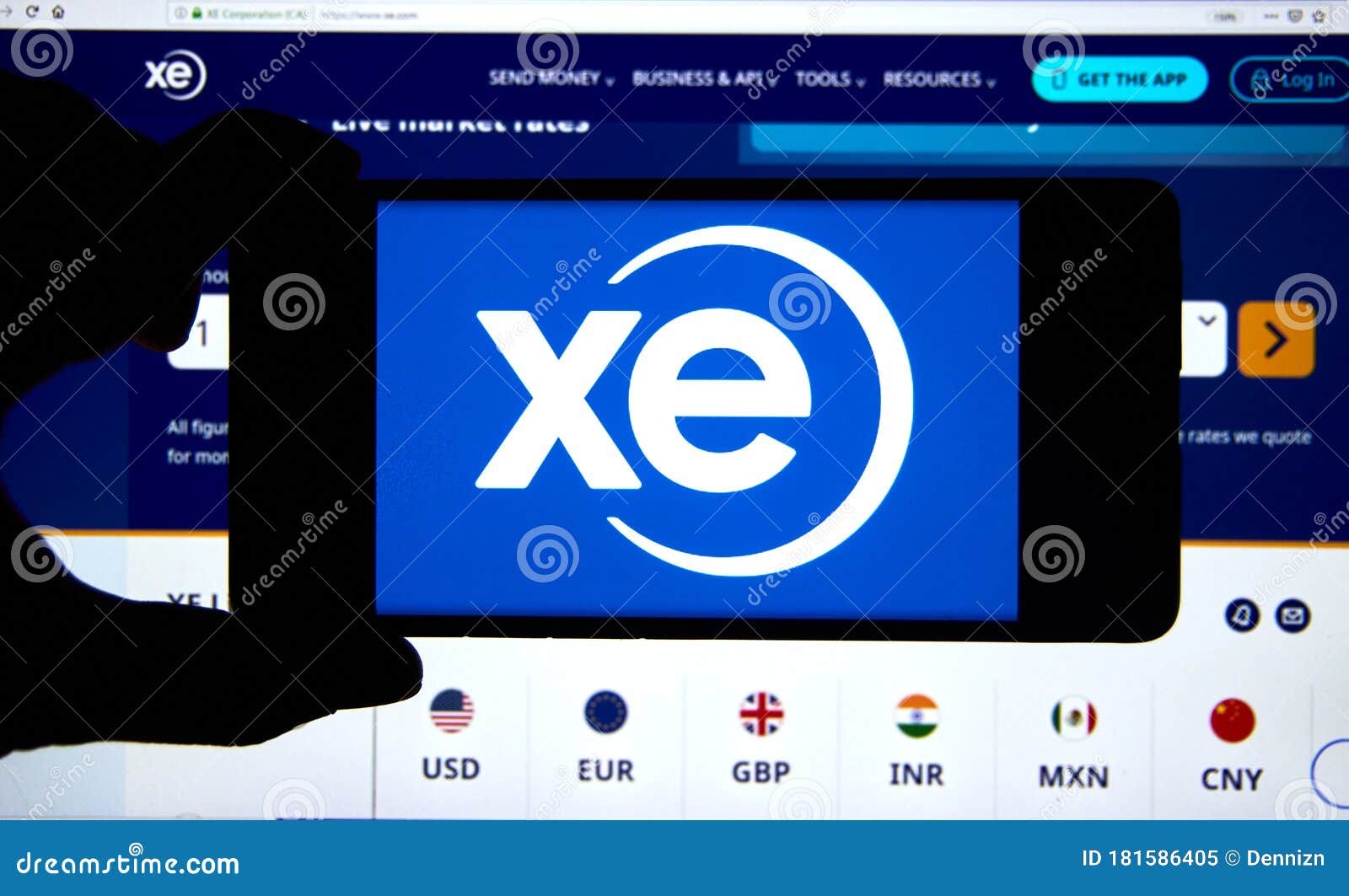 Xe.com Logo and Application on a Cell Phone Over an Official Web Site ...