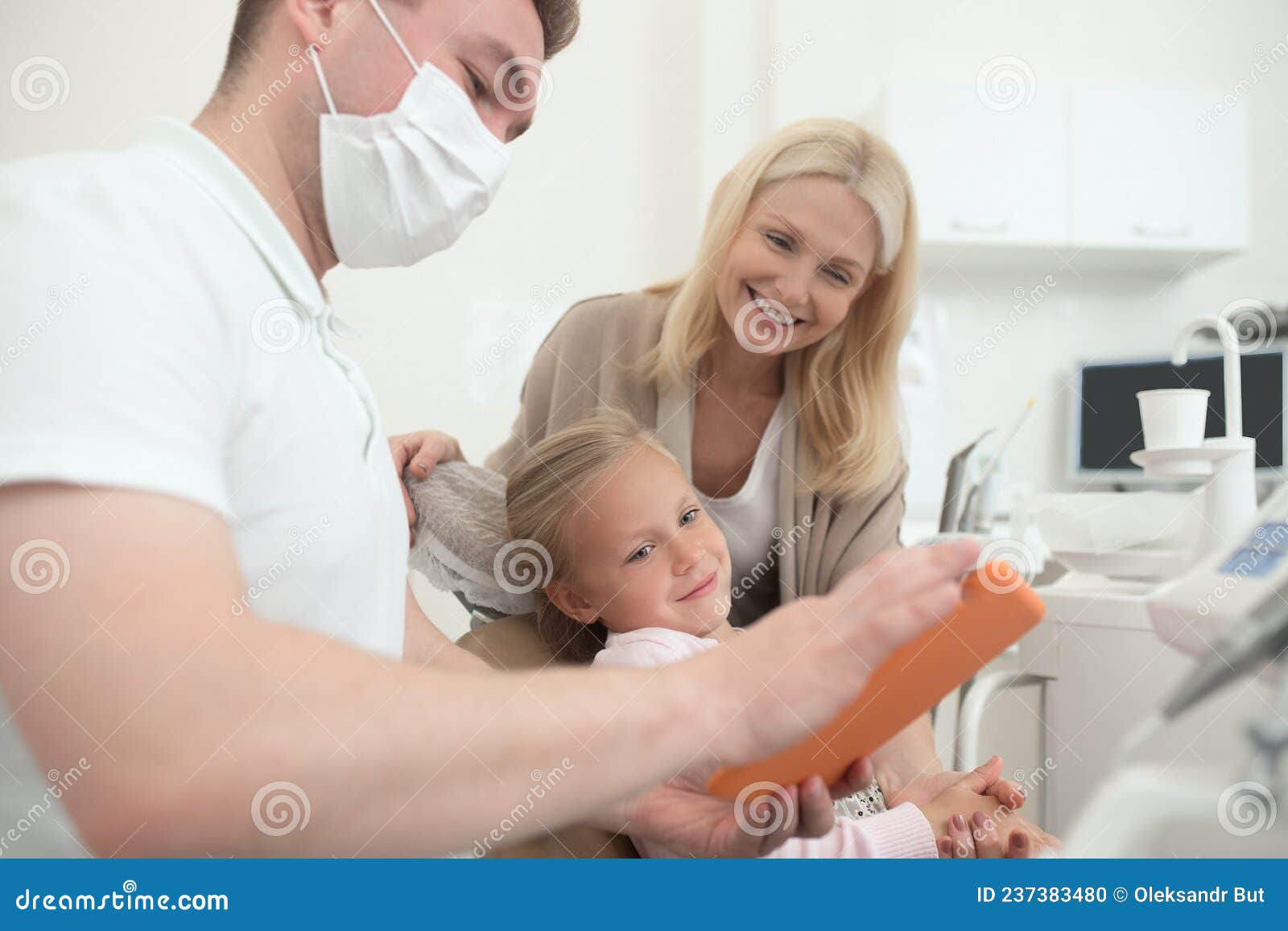 a male doctor expaining the xray results to the kids mom