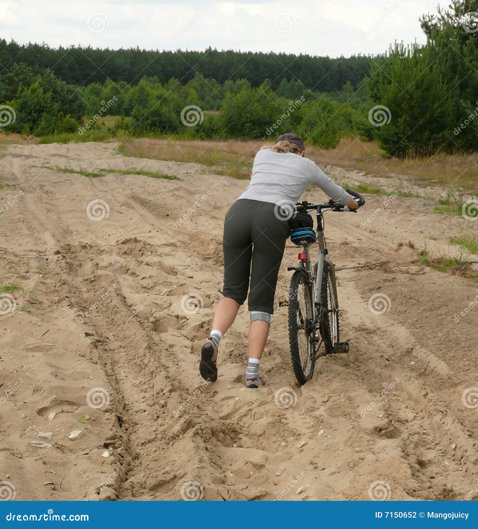 Xtreme Biking. Pushing Bike through the Sands Stock Photo Image of