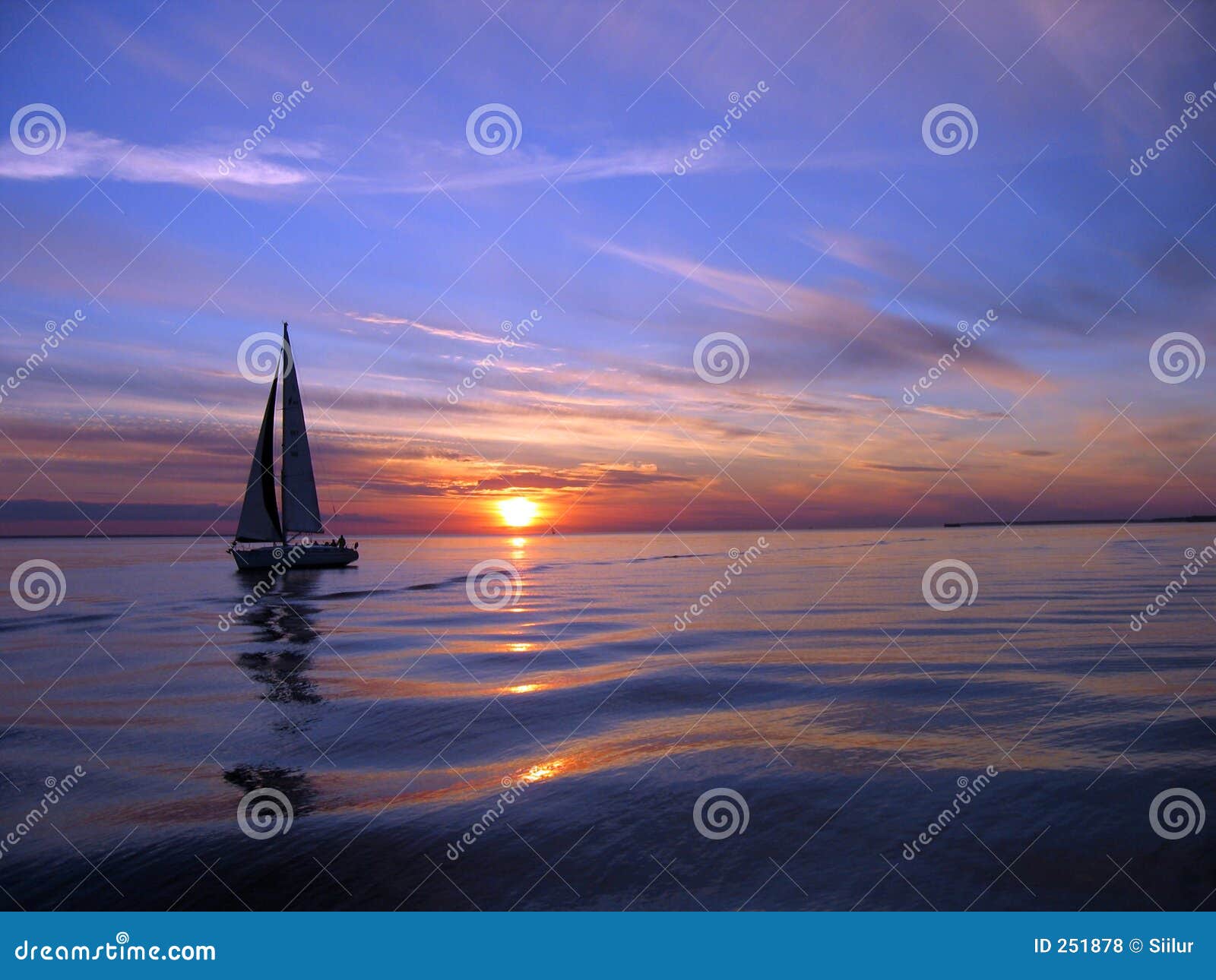 yacht sailing at sunset