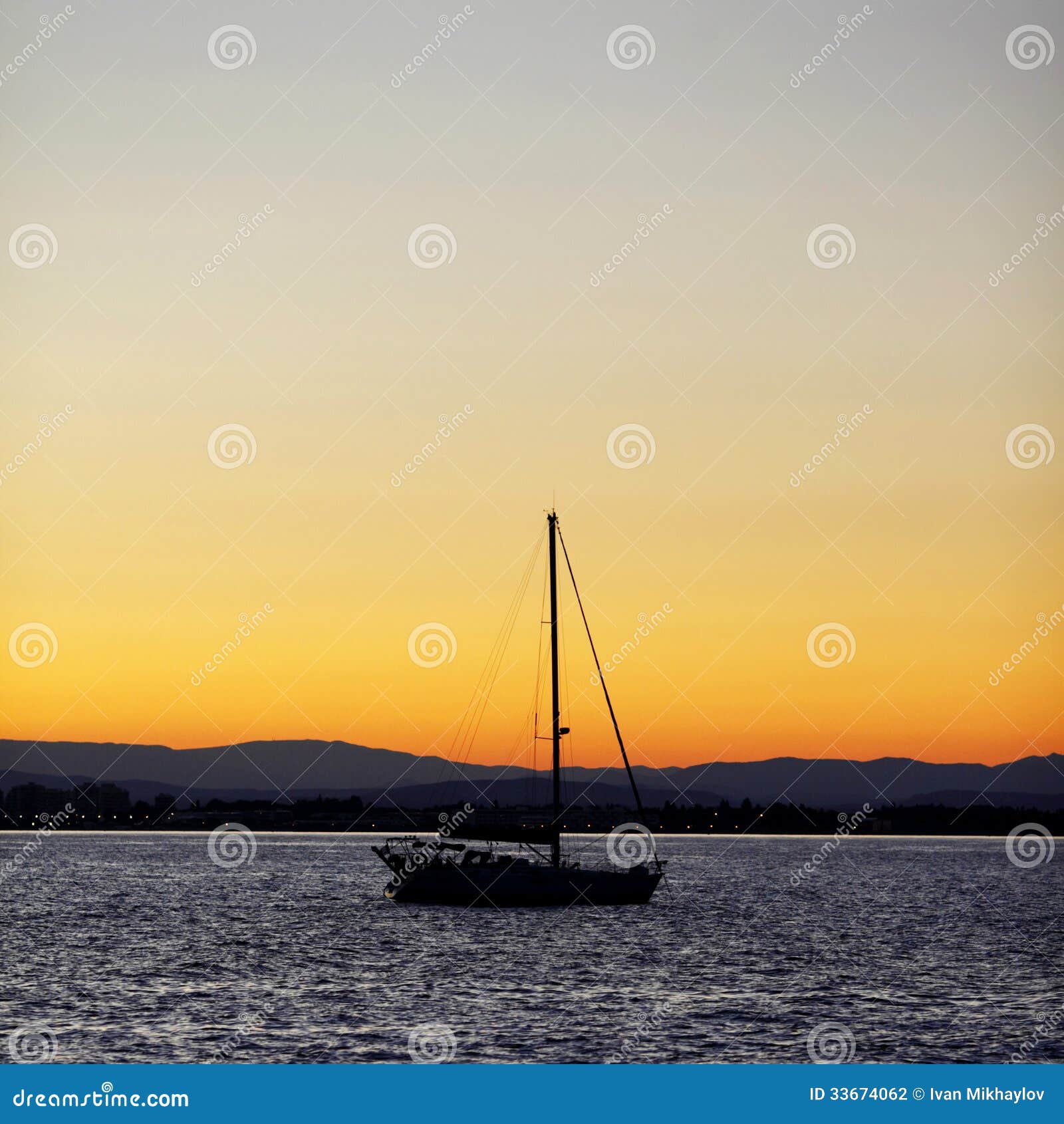 Silhouette of a yacht in the sea at sunset