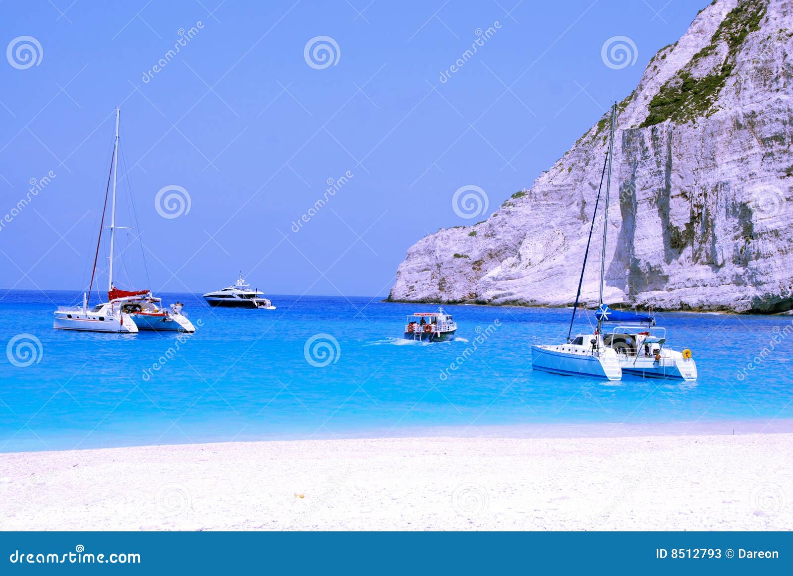 Yachts in Navagio Bay - Zakynthos. Navagio, wreck Bay on Zakynthos Island (Zante) in Greece. Blue sea, catamaran, yachts and white sandy beach.