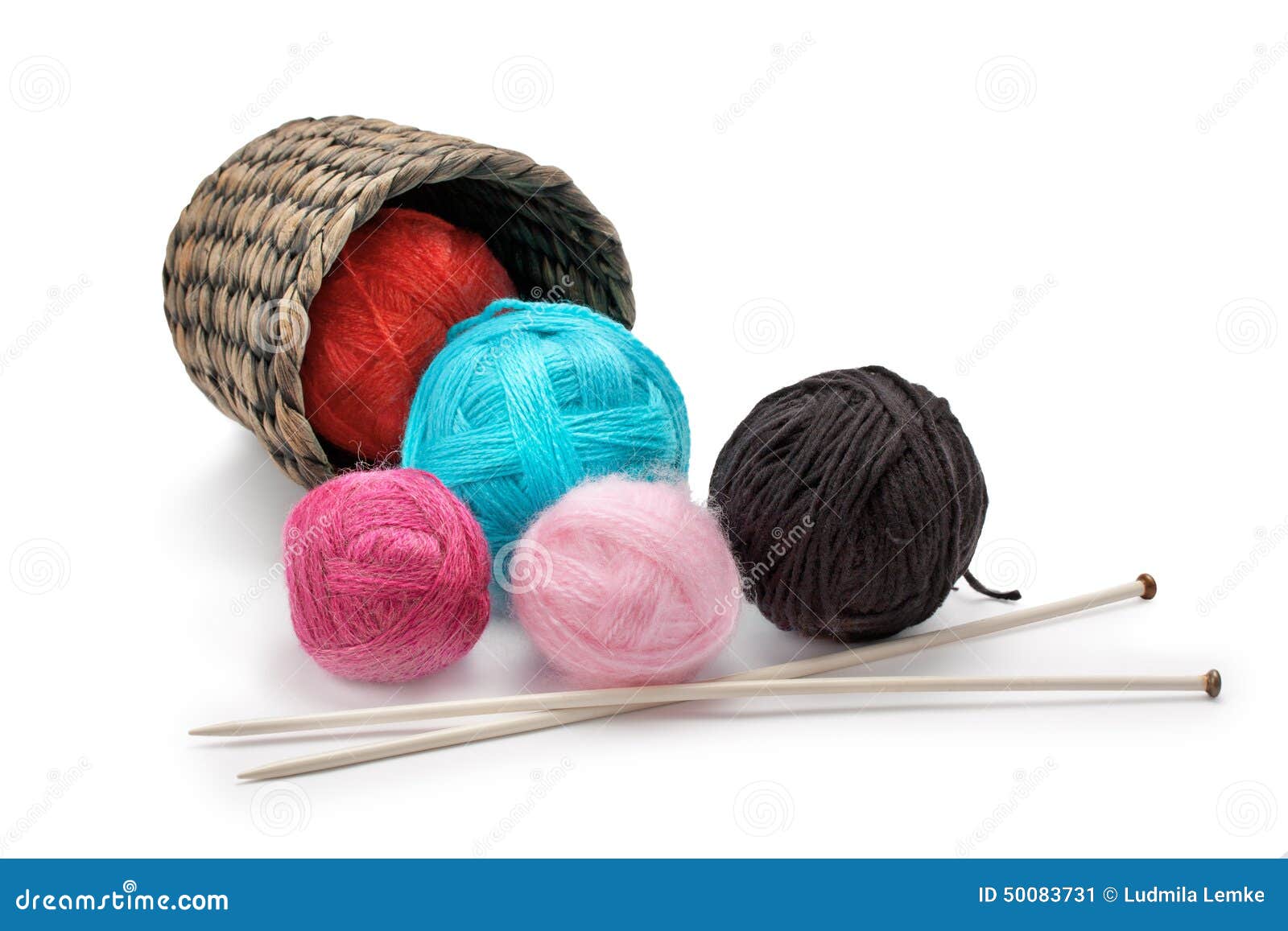 yarn and knitting needles arranged in a basket