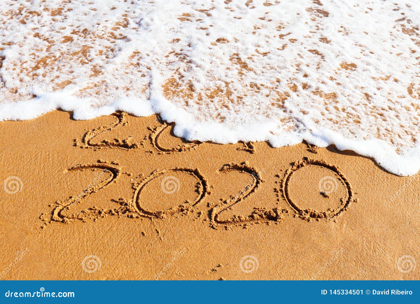 Year Drawn On The Sand Being Washed Away By A Wave Stock Image Image Of December