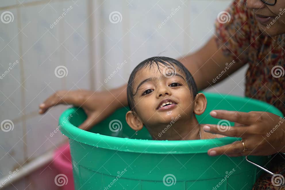 2 year old Indian Baby Boy Enjoying A Bath In A Green Tub Stock Photo 2-year-old-indian-baby-boy-enjoying-a-bath-in-a-green-tub-stock-photo