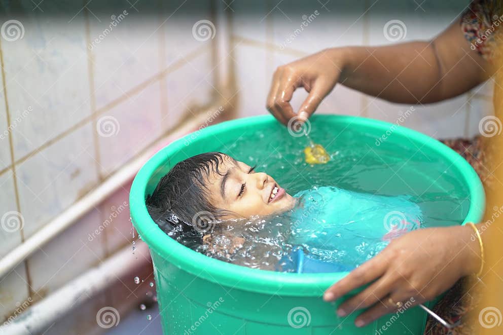 2 year old Indian Baby Boy Enjoying A Bath In A Green Tub Stock Image indian-food-chart-for-1-year-old-baby-deporecipe-co