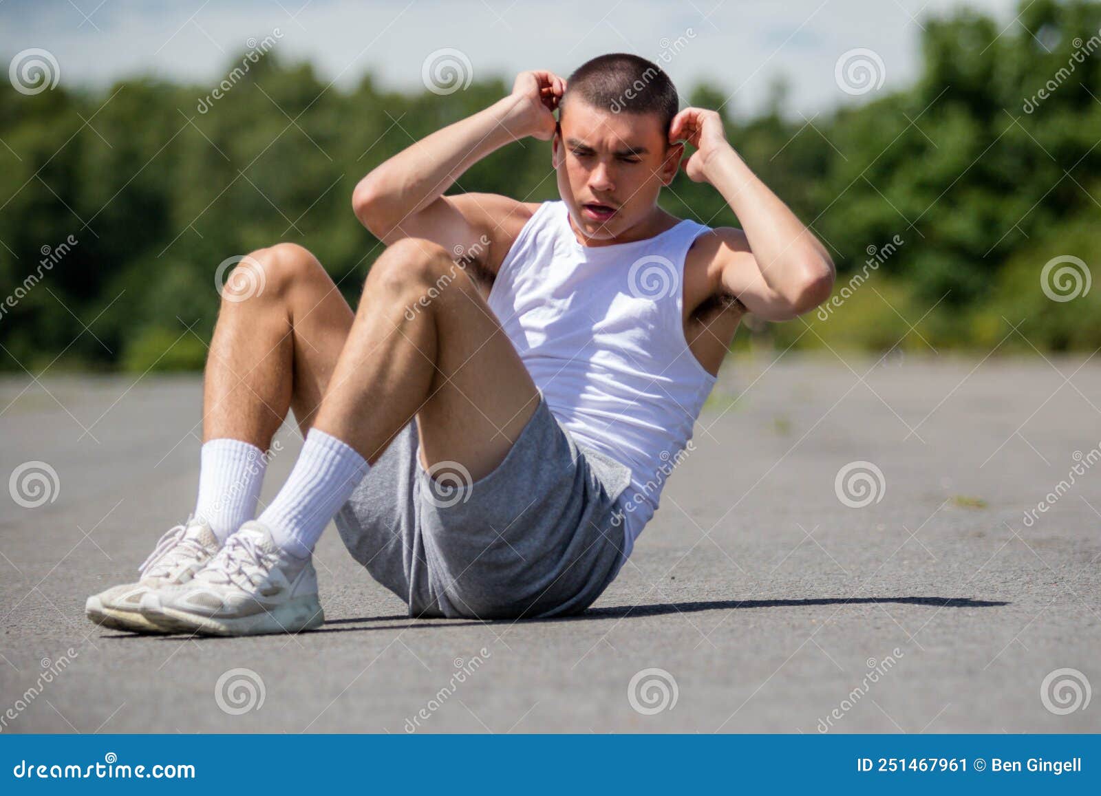 A 19 Year Old Teenage Boy Doing Situps in a Public Park Stock Image ...