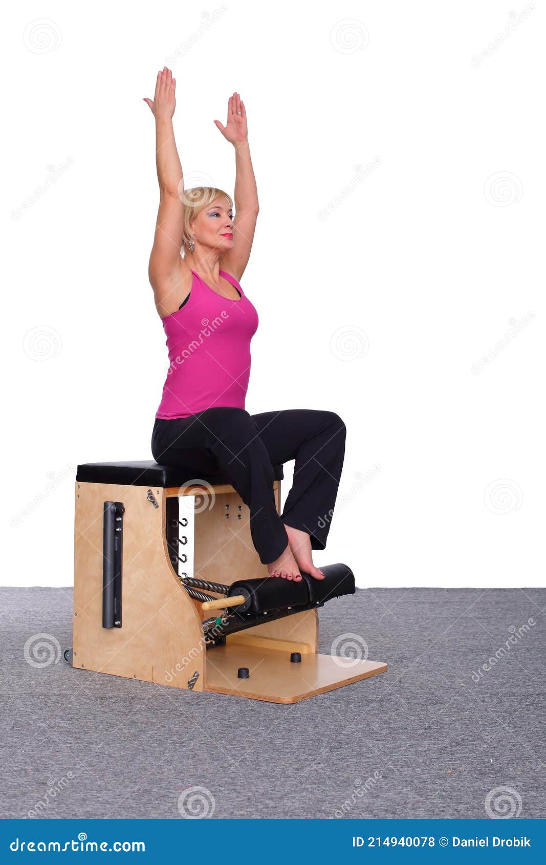 A 50-year-old Trainer Practices Pilates on an Elevator Chair