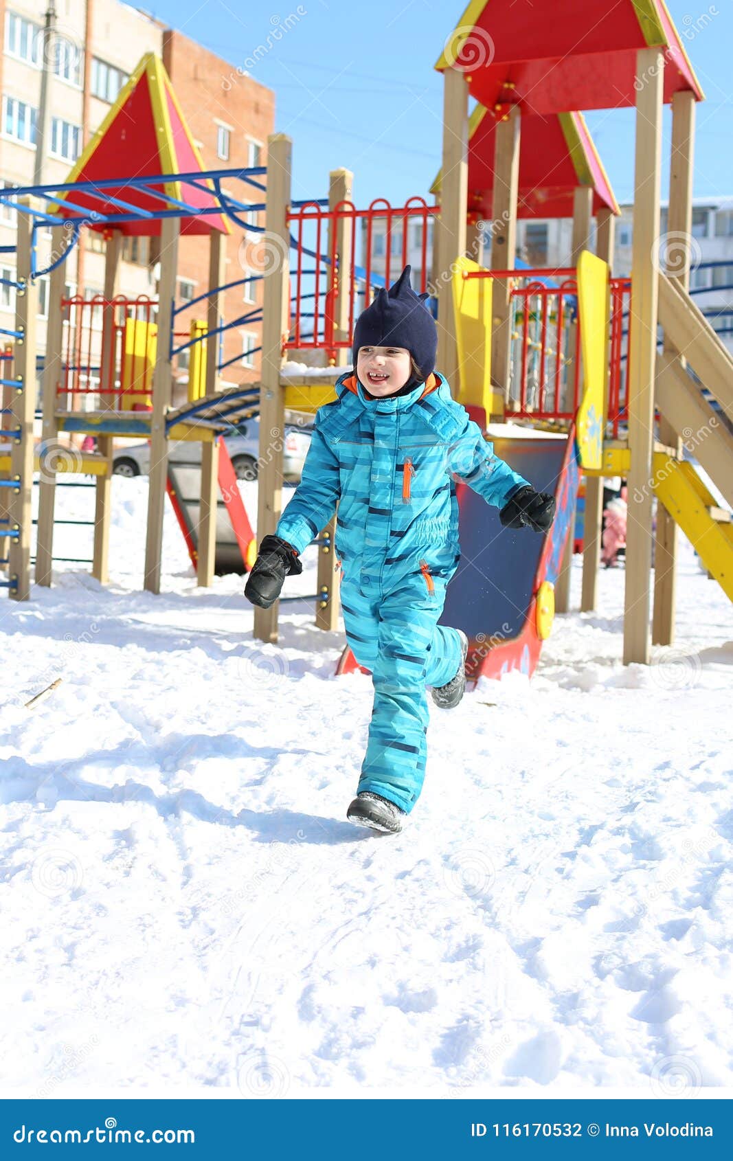 5 Years Little Boy in Warm Overall Runs Outdoors in Winter Stock Photo