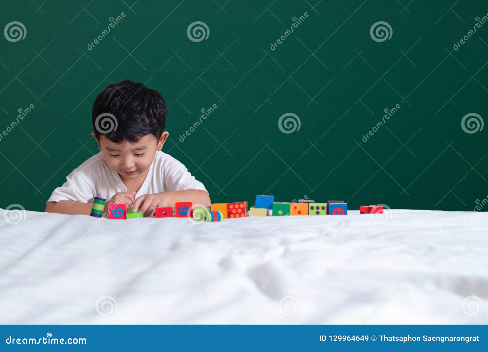 3 Years Old Asian Boy Play Toy Or Square Block Puzzle On Green C St