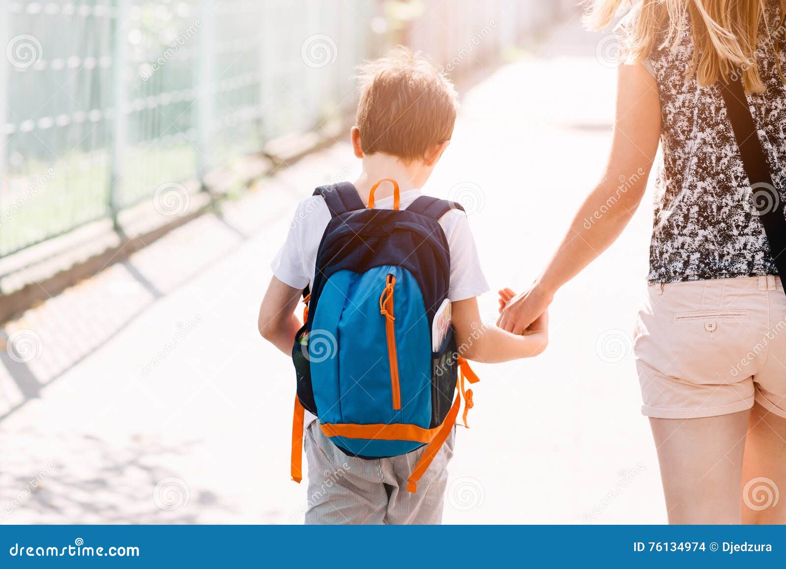 7 years old boy going to school with his mother