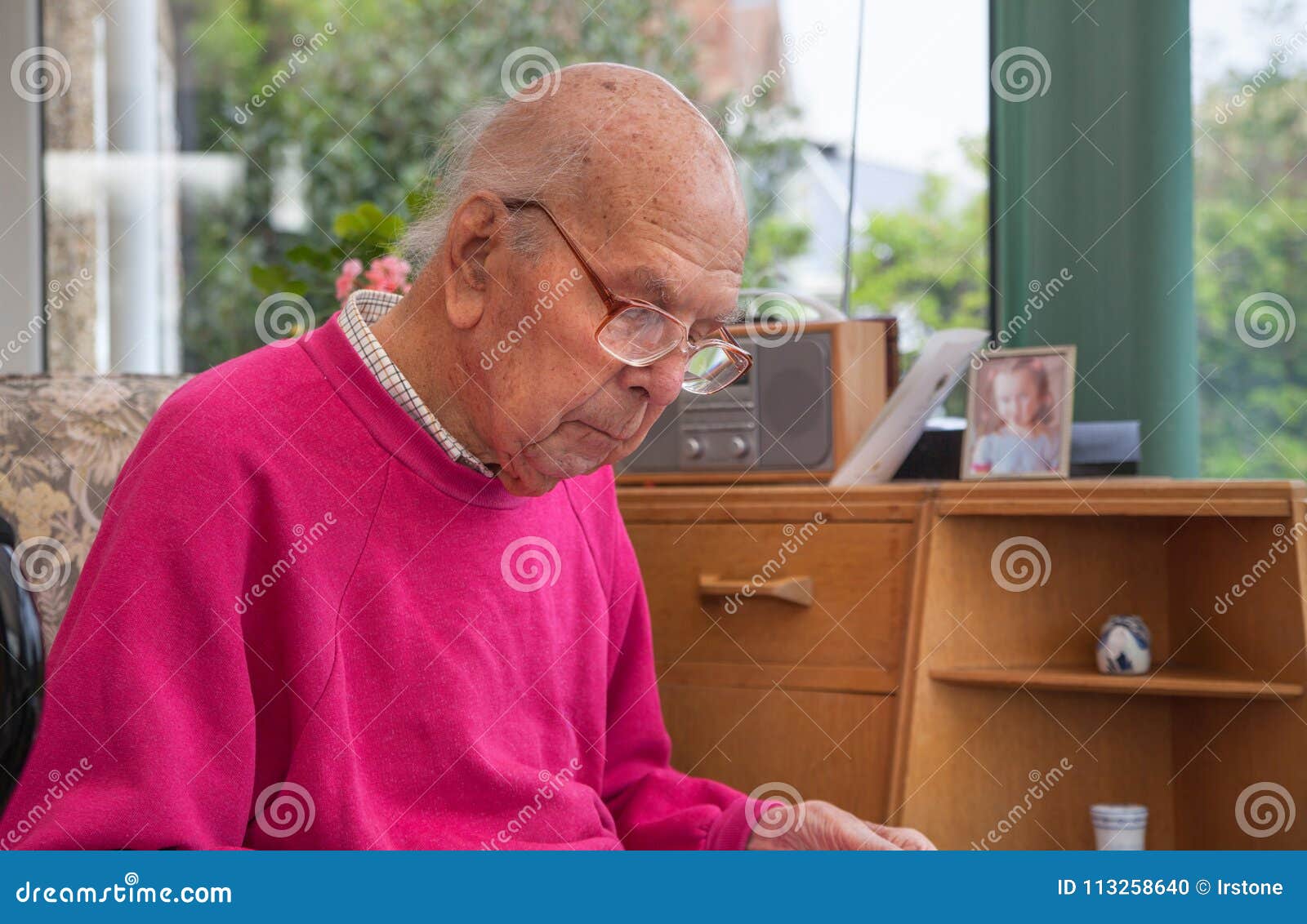 95 Years Old English Man Sitting In Chair In Domestic Environment