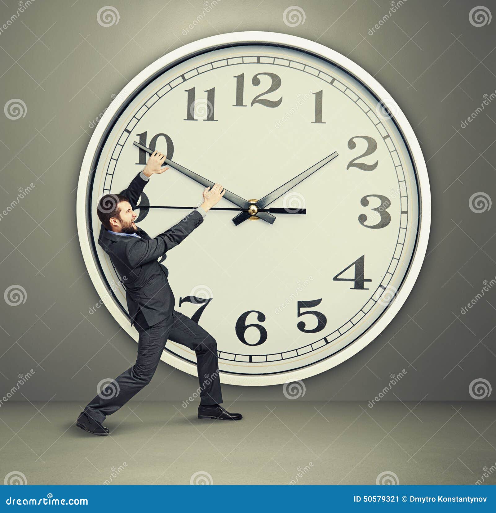 Businessman trying to stop time Stock Photo by ©kantver 69891211