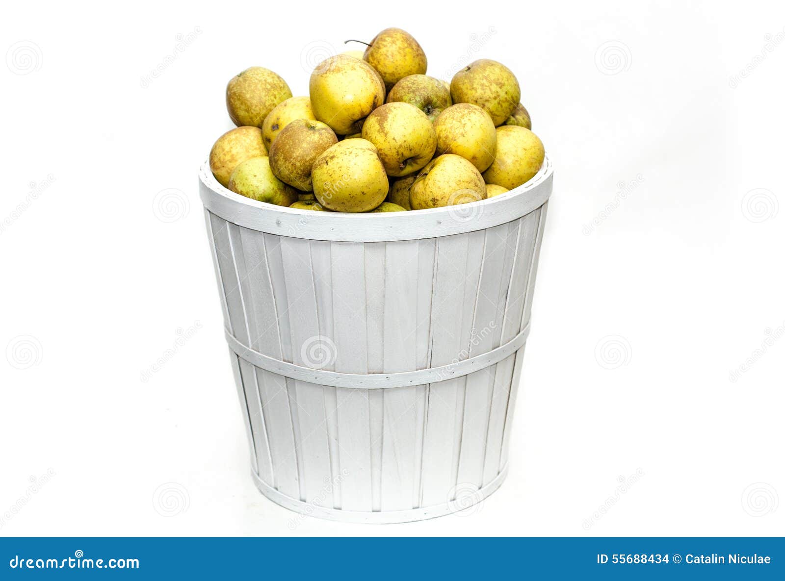 Yellow apples in a white basket