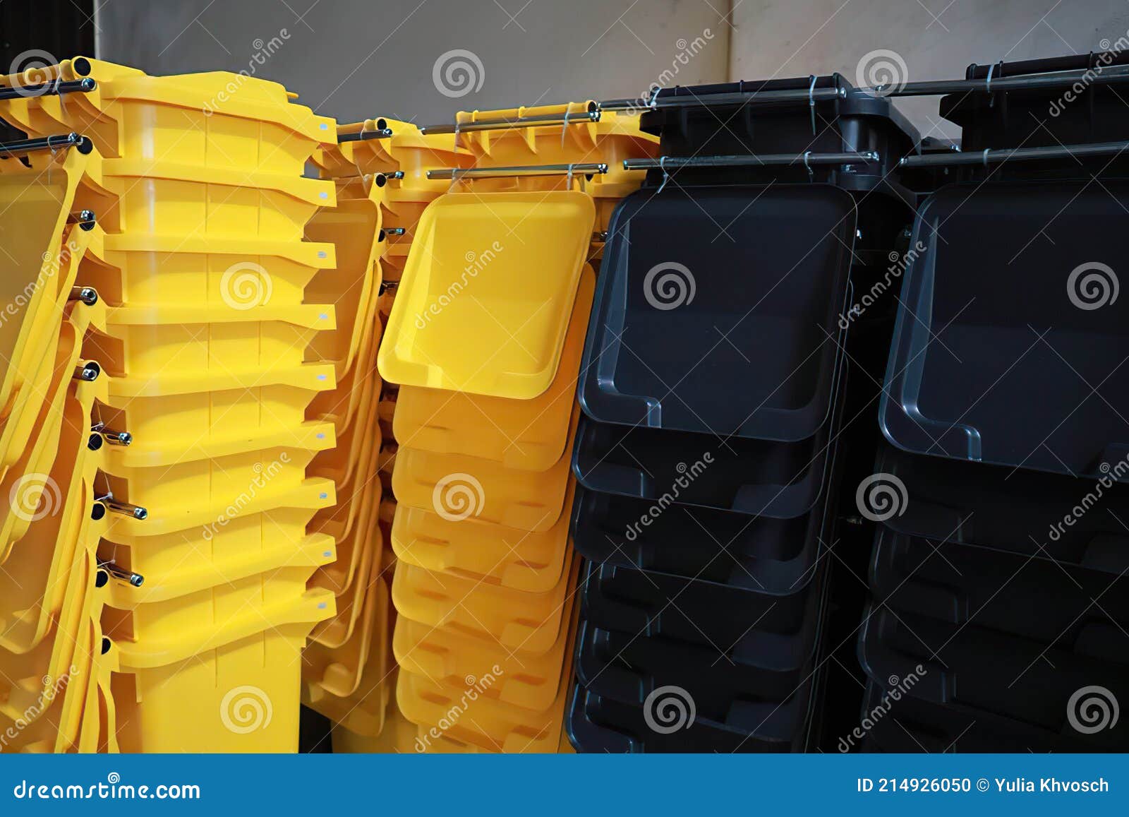 Yellow and Black Plastic Dumpsters for Separate Garbage Collection on a