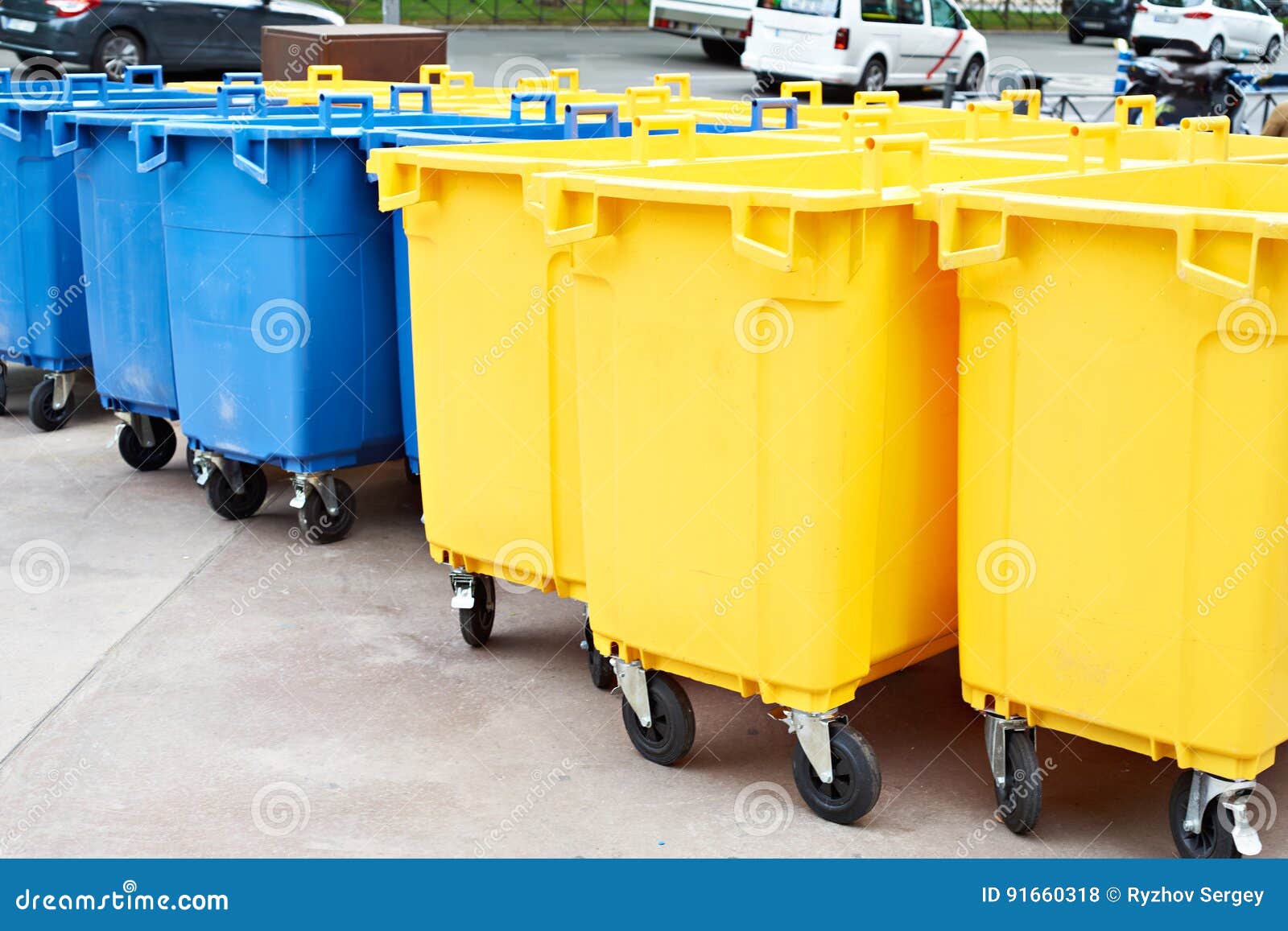 Yellow and Blue Plastic Garbage Cans on City Street Stock Photo Image